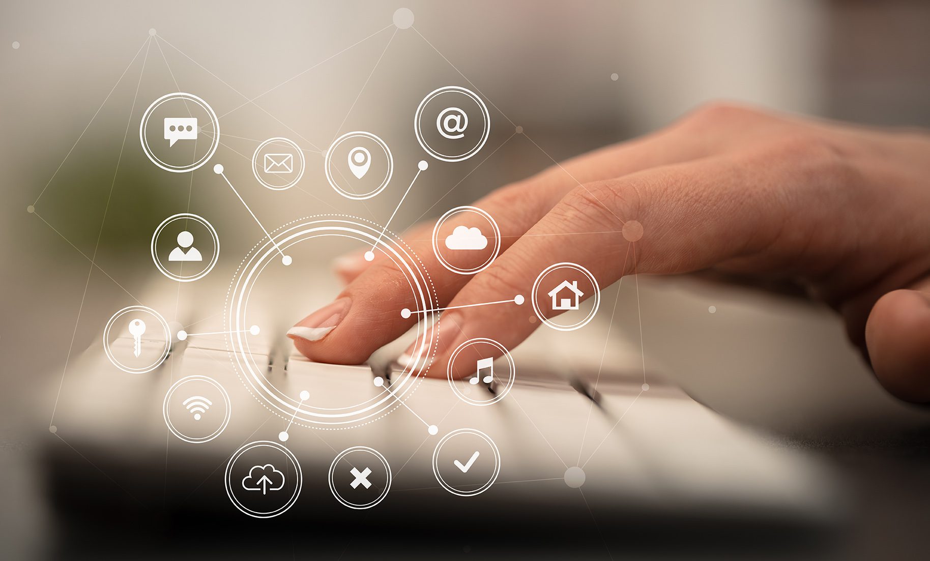 Hand typing on keyboard with application icons around Hand touching keyboard