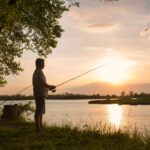man fishing during sunset