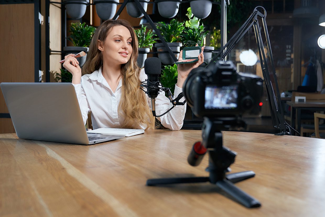 Blogger woman preparing for interview on camera in cafe. photo of vlogger